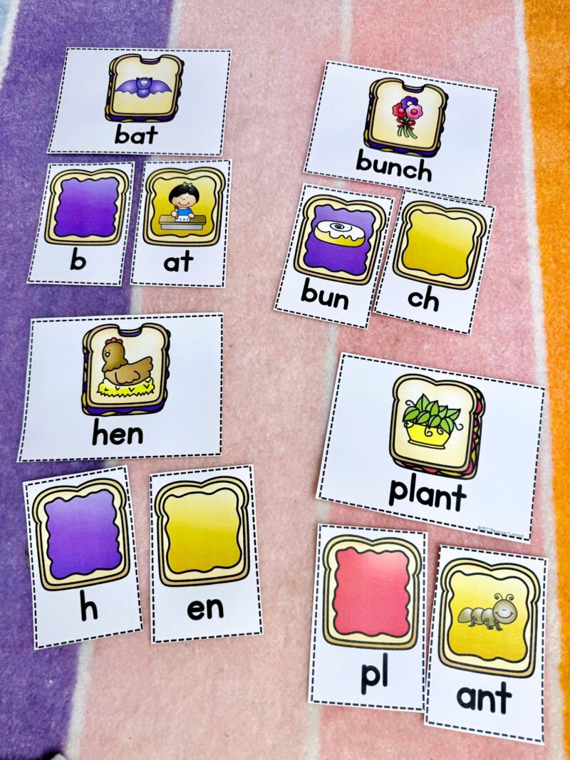 Kindergarten free ELA station featuring CVC word building cards with pictures and letter tiles. Students match beginning consonants and rimes to build words like pin and bat, supporting phonics blending and decoding skills aligned to the Science of Reading.