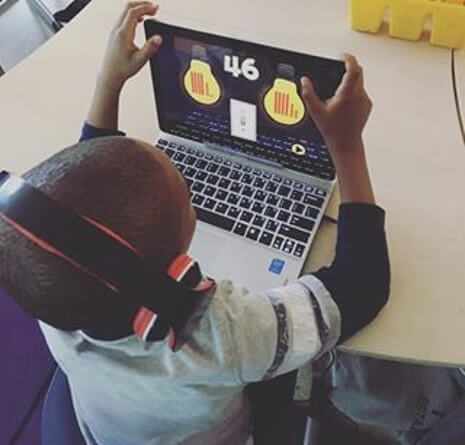 student working on place value on a laptop