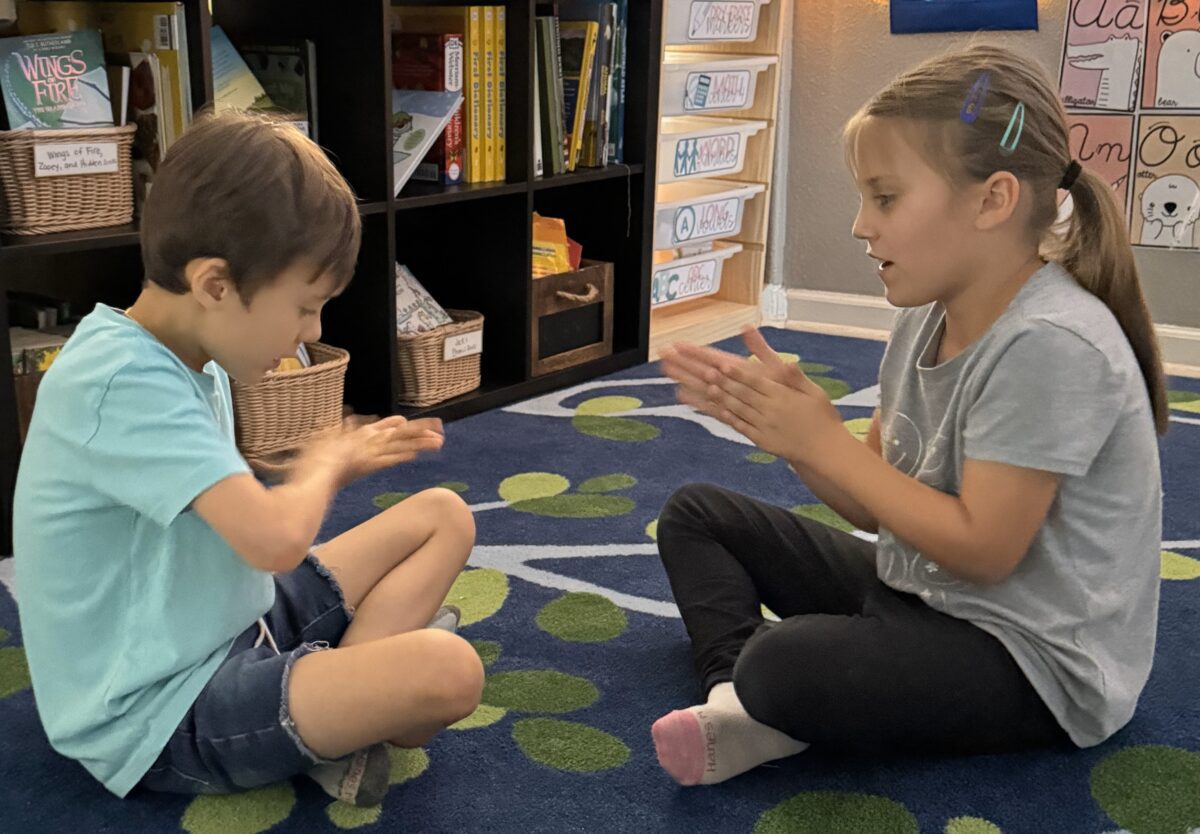 students collaborating together on the rug. 