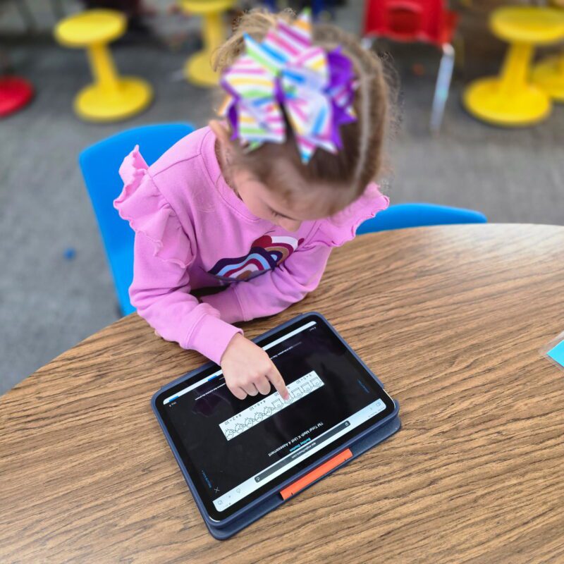 kindergarten student using ESGI and Total Math on a device.