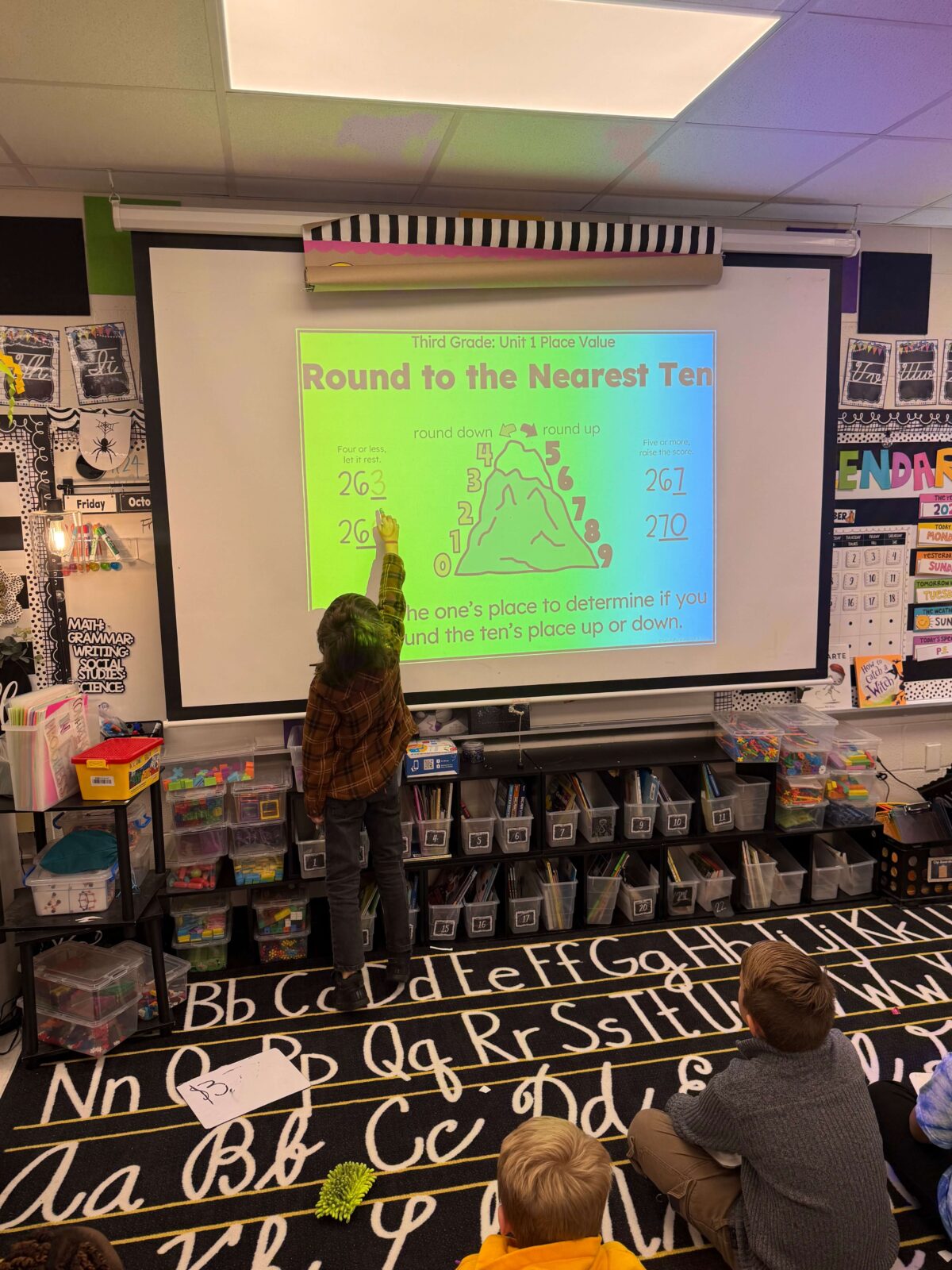 Student interacting with third grade teaching slides