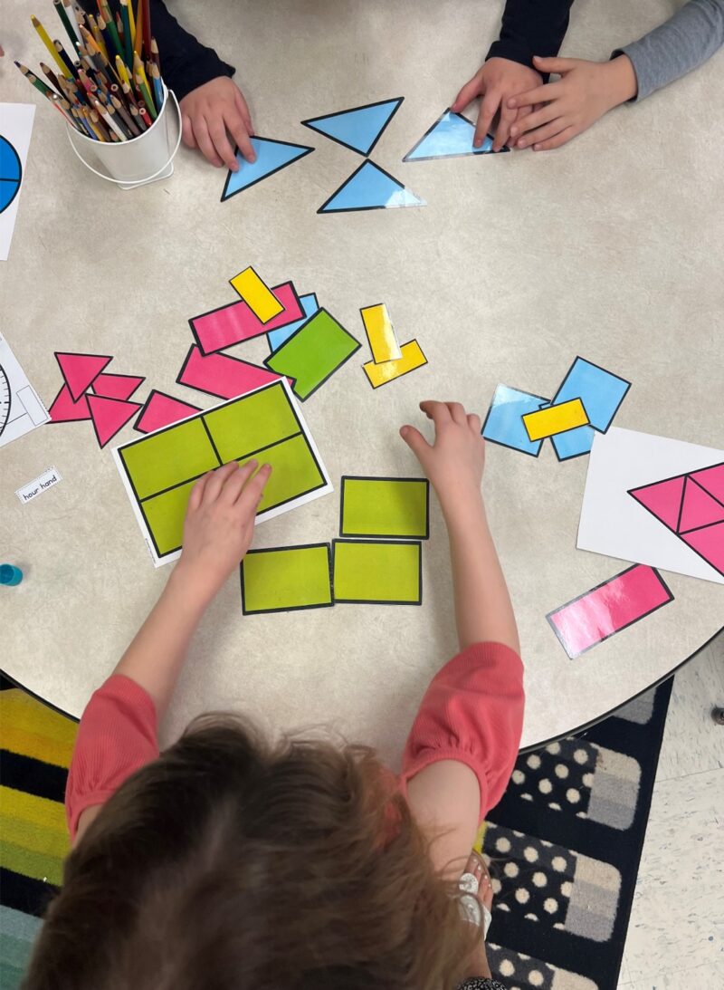 First grade students exploring equal parts using hands-on geometry models