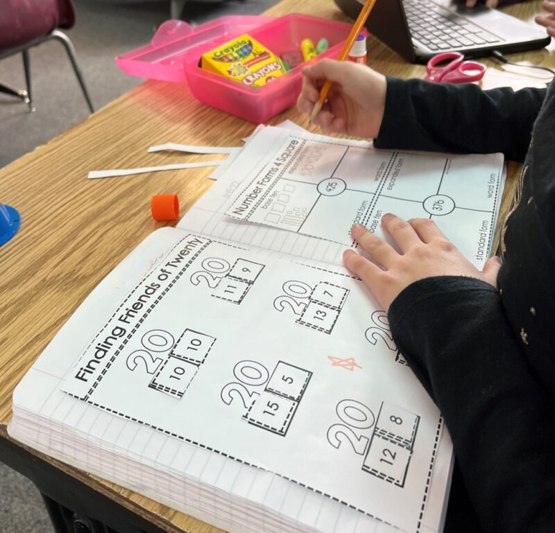 student completes a math journal during math workshop